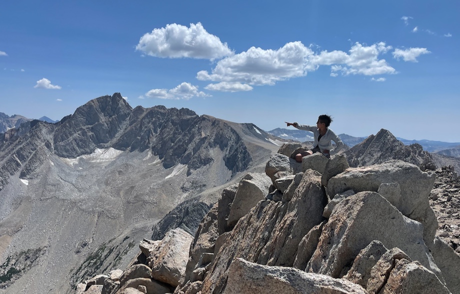 Alicia points out notable peaks from the summit. That's Mount Humphreys back and to the left.