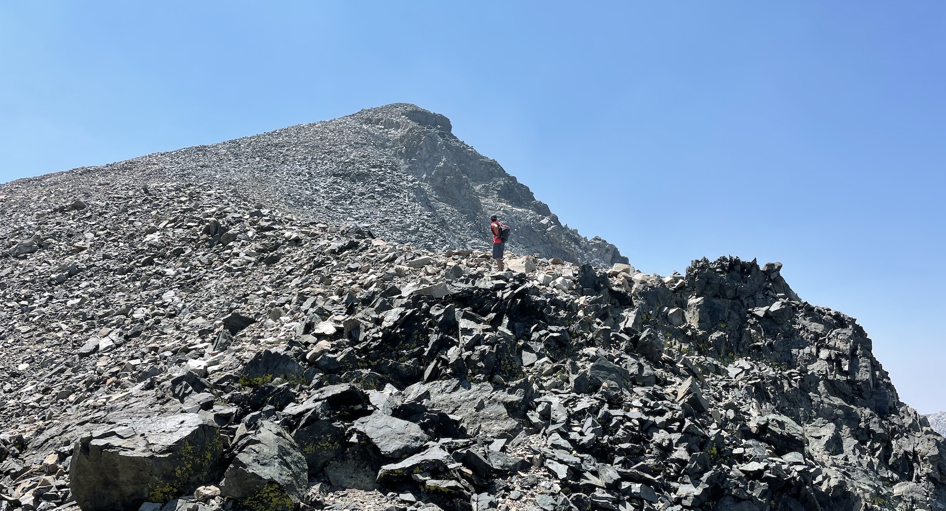 Rafee leaves the ridge and begins the last 500 vertical feet of easy talus to the summit.