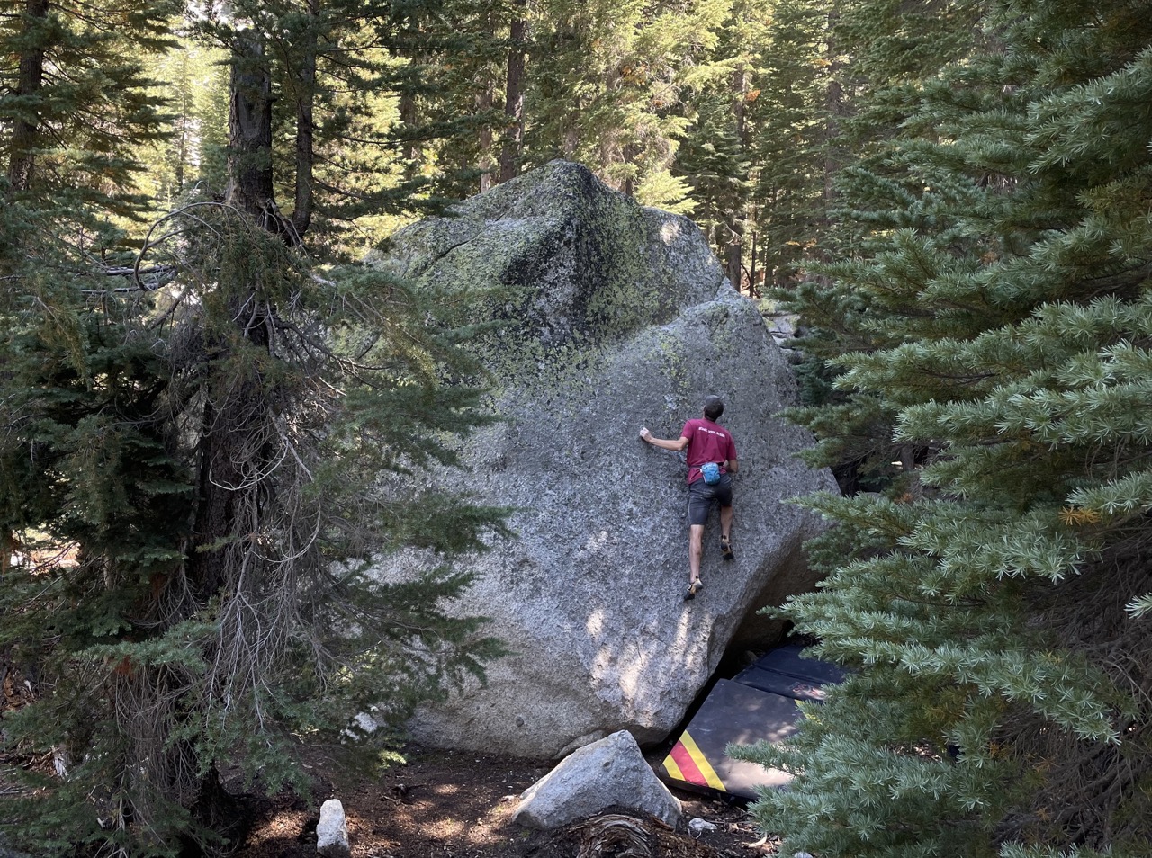 Bravely climbing the v4 slab without pants protection! on Dura Mater boulder (behind Summertime Boulder)